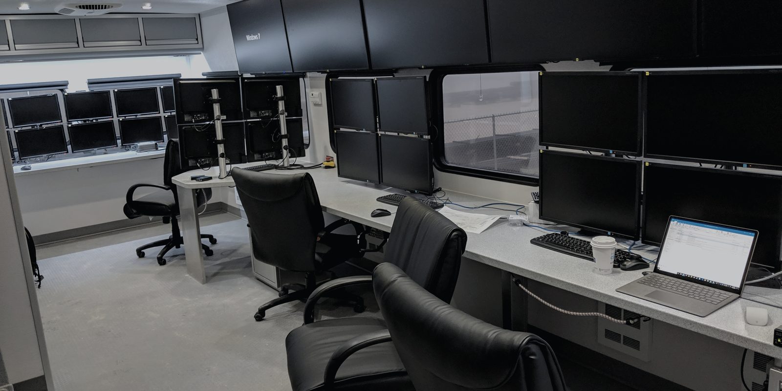 Datavan interior with a wall of screens